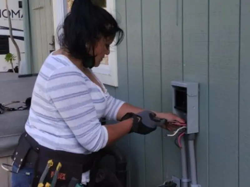 Licensed electrician wiring an exterior subpanel in Delavan