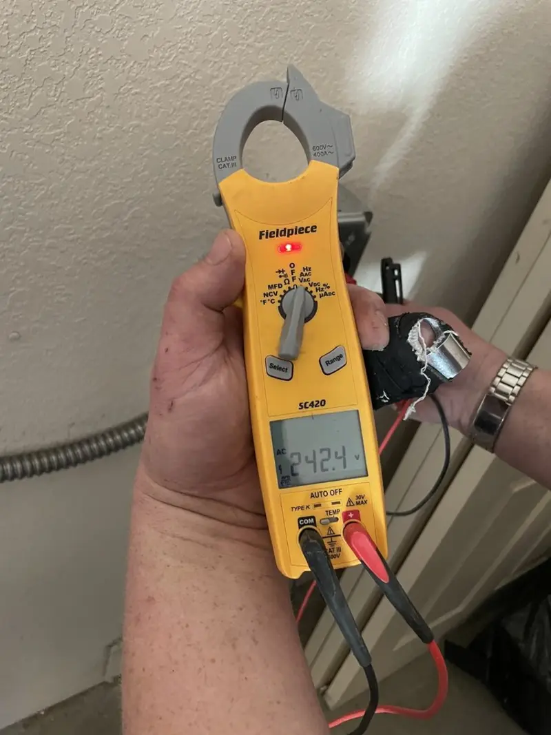 Voltage testing with clamp meter during Ceiling Fan Installation in Delavan